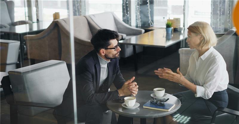 Image of 2 people discussing